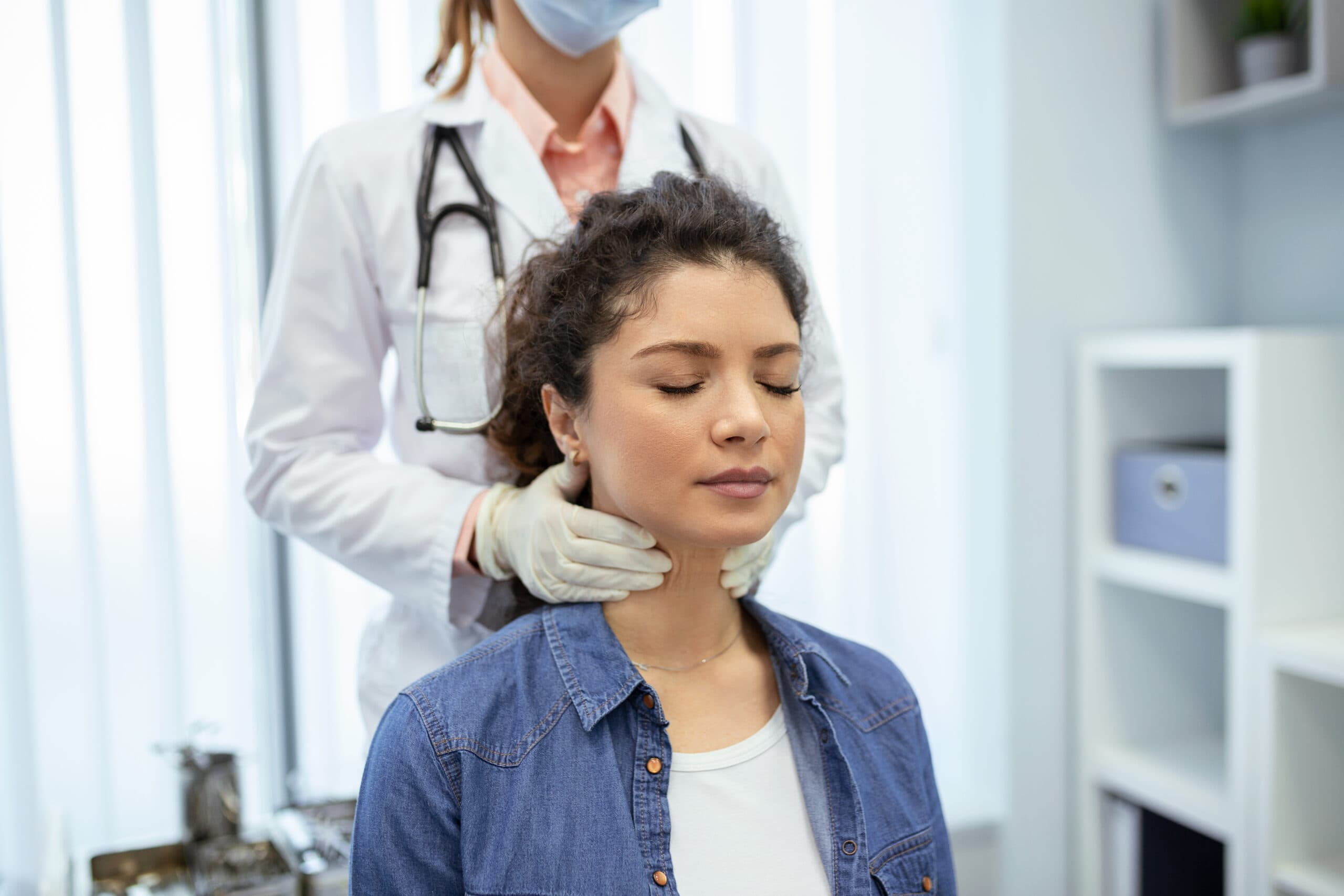 Woman examining hair for thyroid-related hair loss