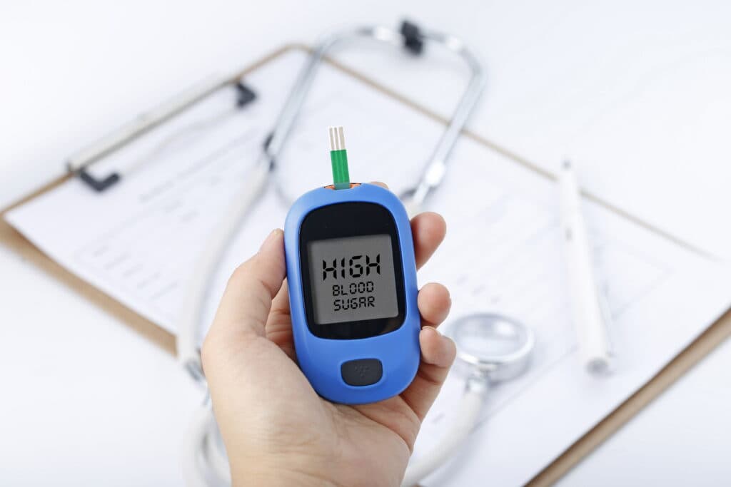 hand-holding-a-blood-glucose-meter-measuring-blood-sugar
